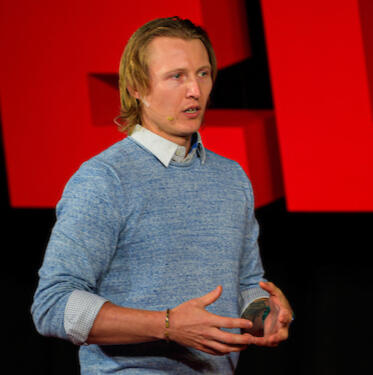 A waist-up photograph of Dr. Colombo-Dougovito. He is a white male in his late 30s.
